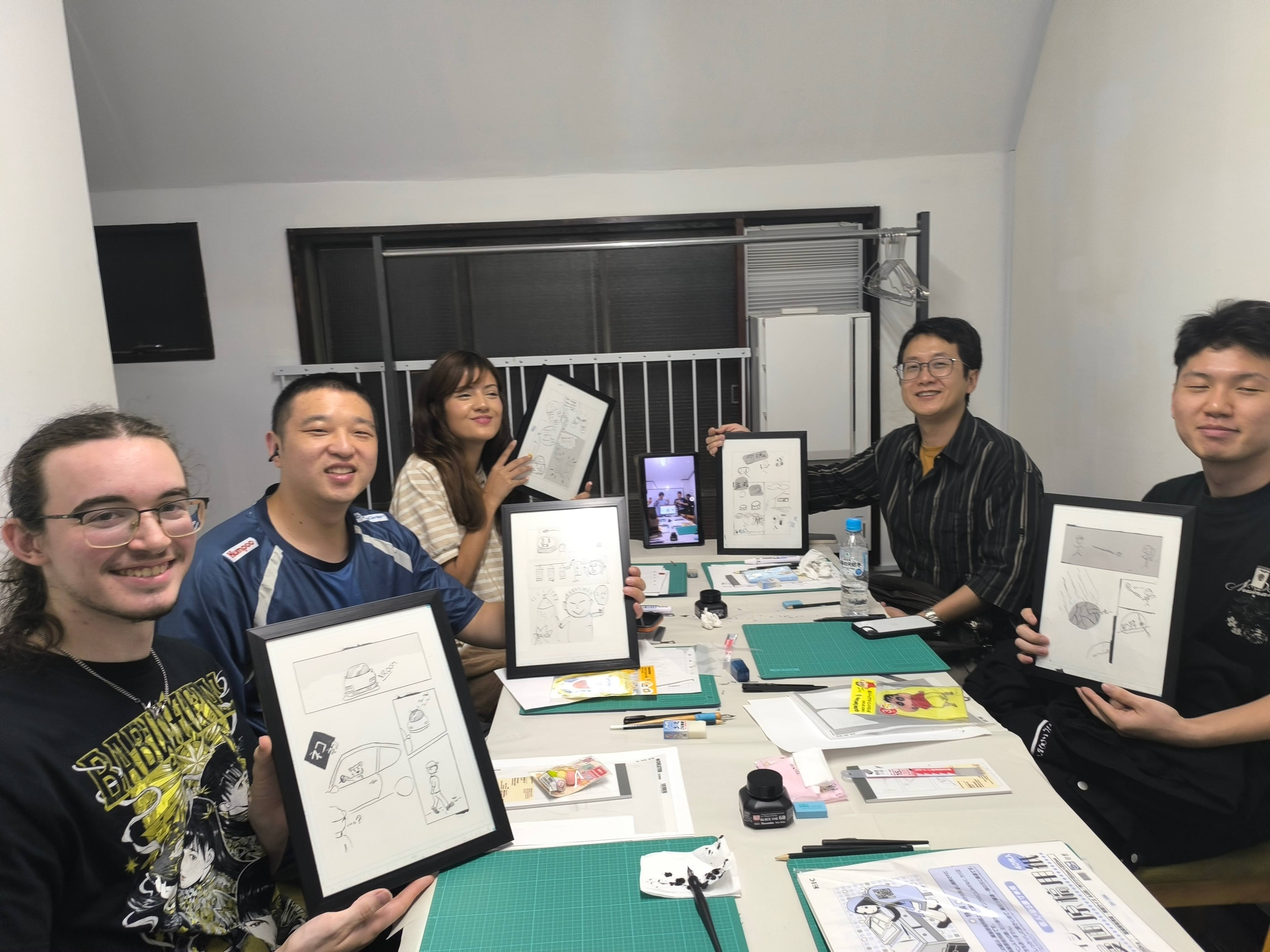 Overhead view of 4-panel manga being drawn